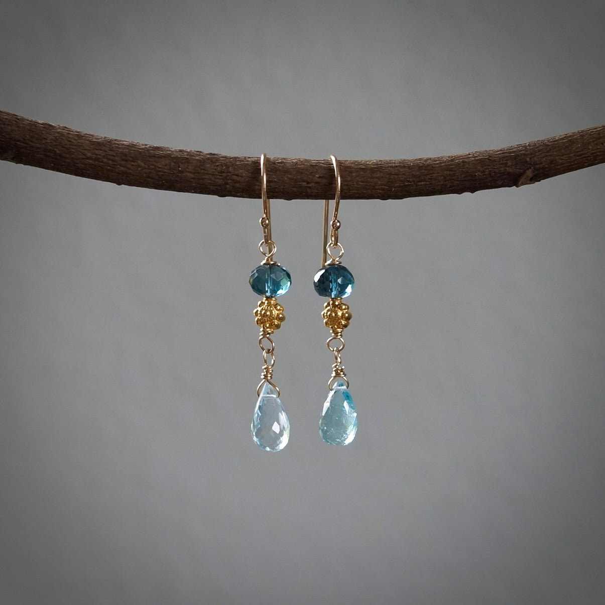 Solid gold earrings with blue topaz