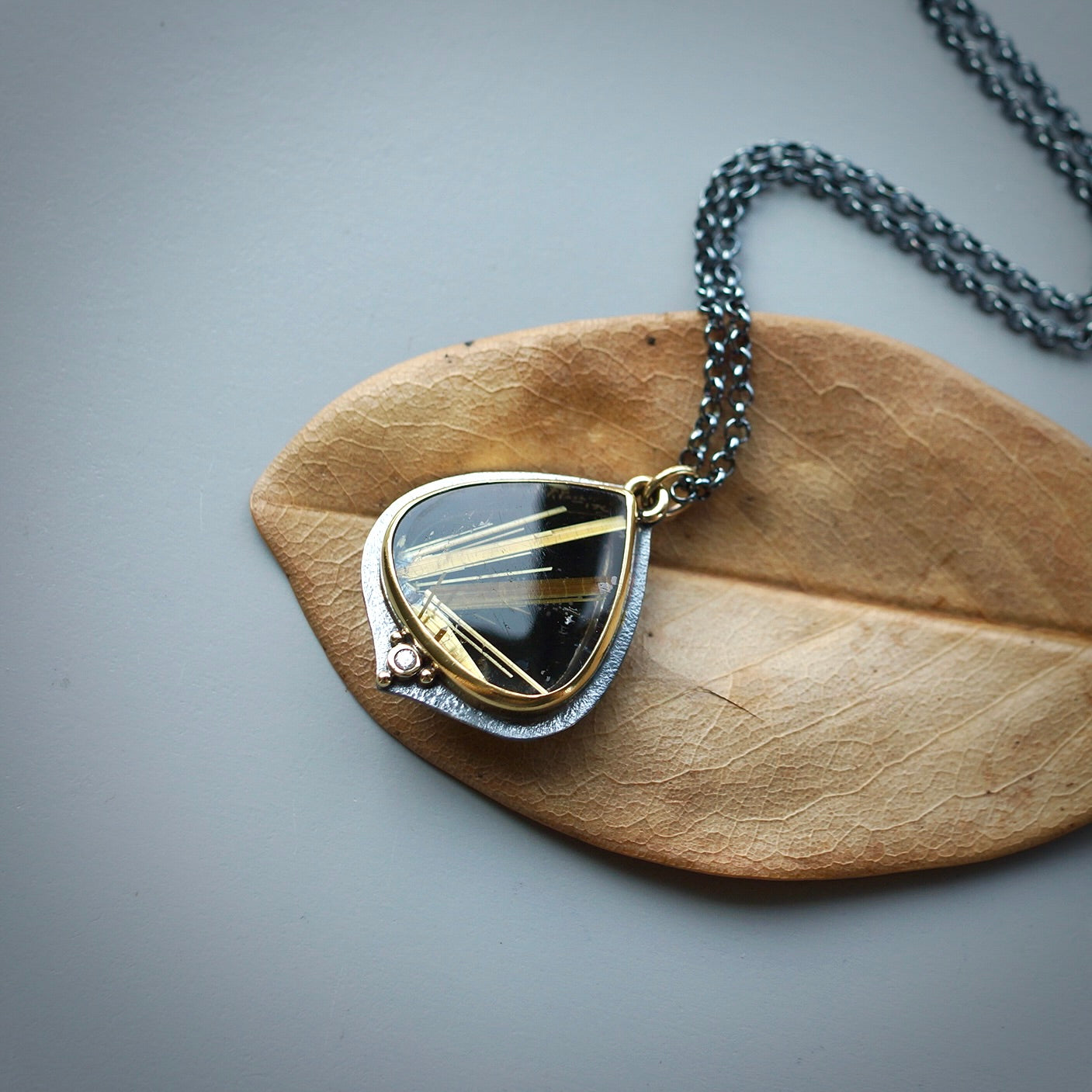 Rutilated quartz and back onyx doublet pendant with diamond