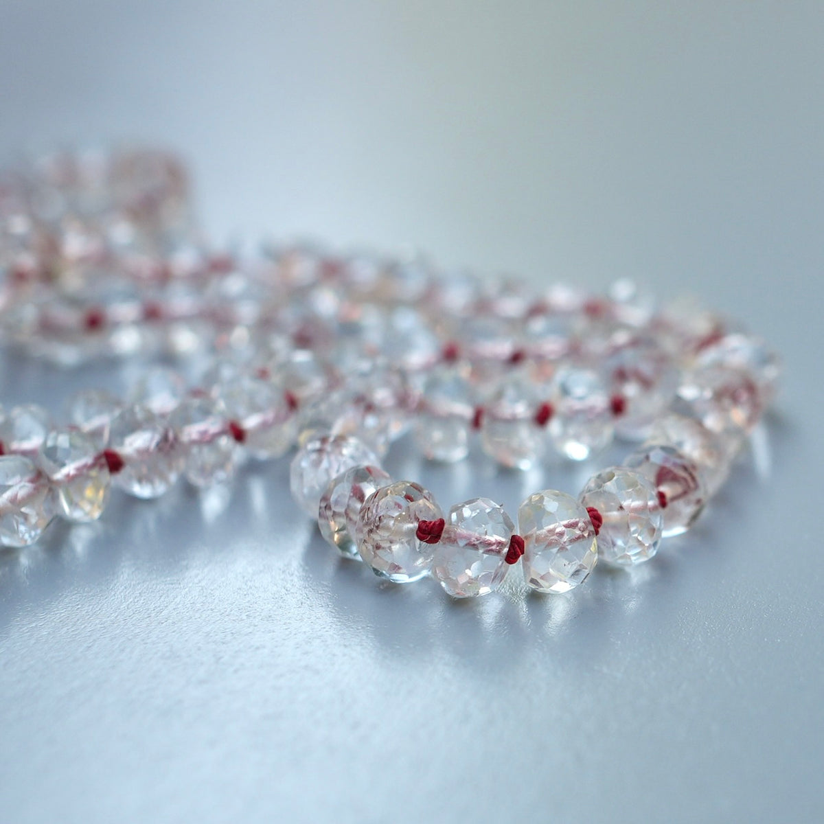 20” White Topaz necklace hand-knotted with red silk