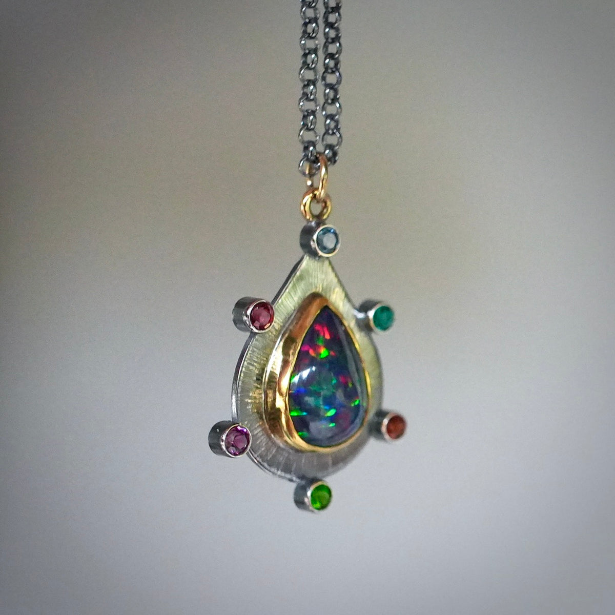 Ethiopian black opal pendant with colorful accents