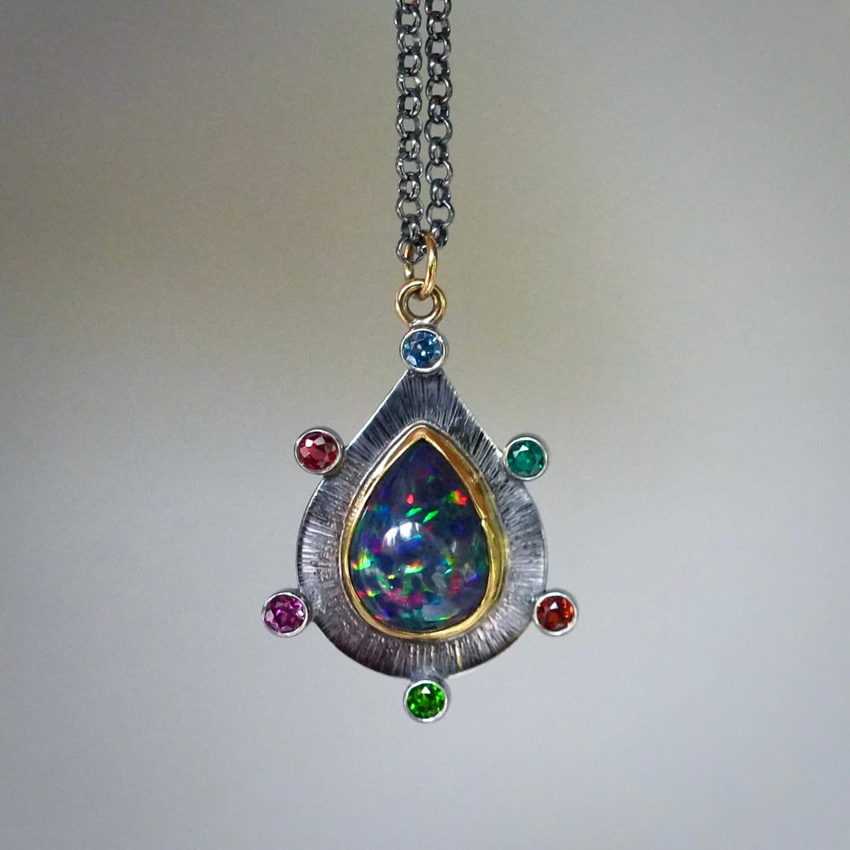 Ethiopian black opal pendant with colorful accents
