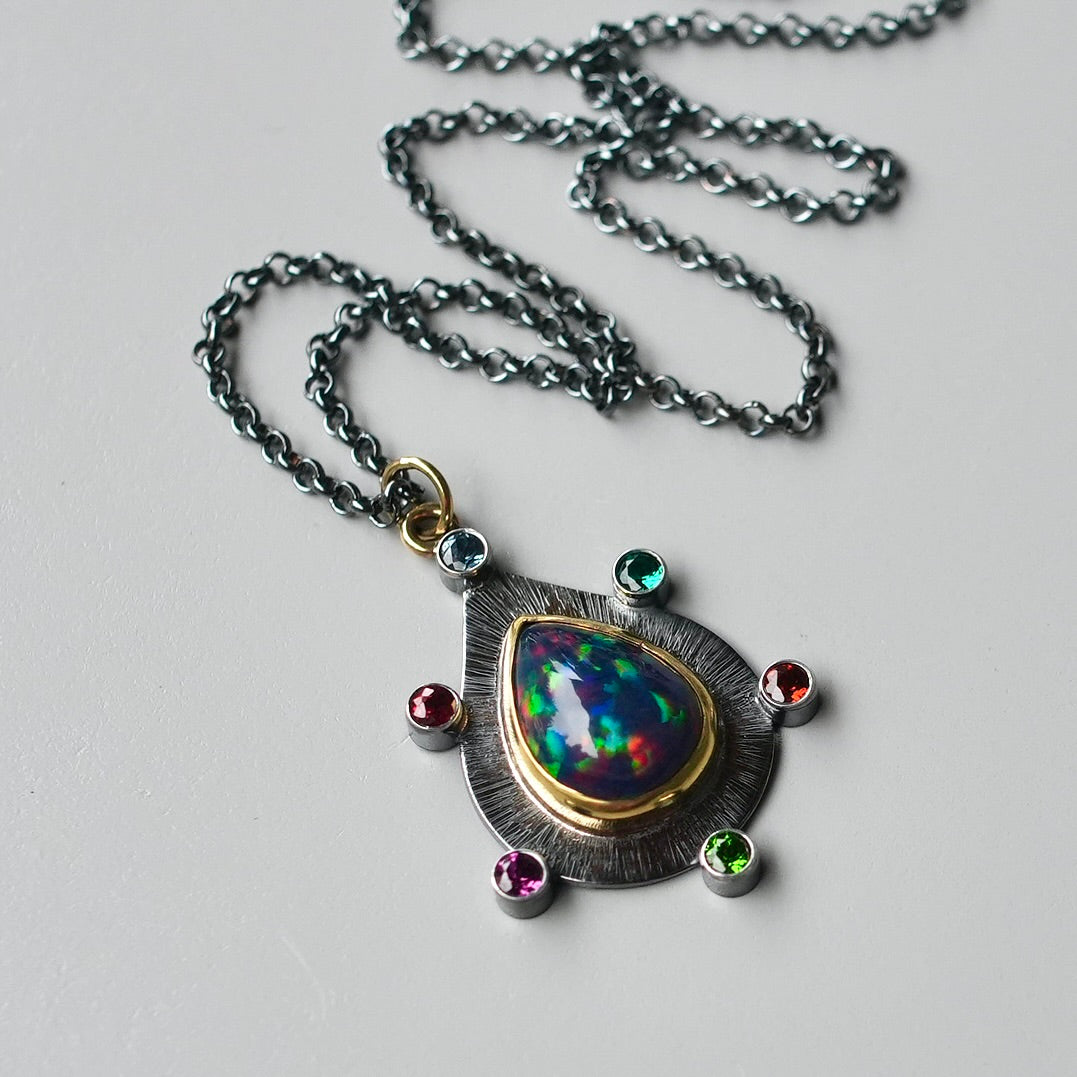 Ethiopian black opal pendant with colorful accents