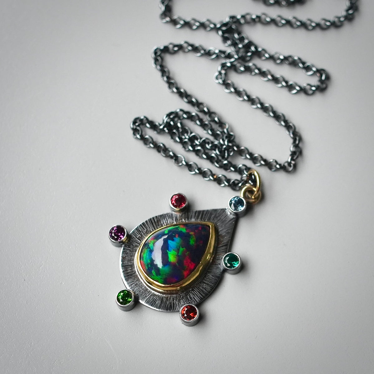 Ethiopian black opal pendant with colorful accents