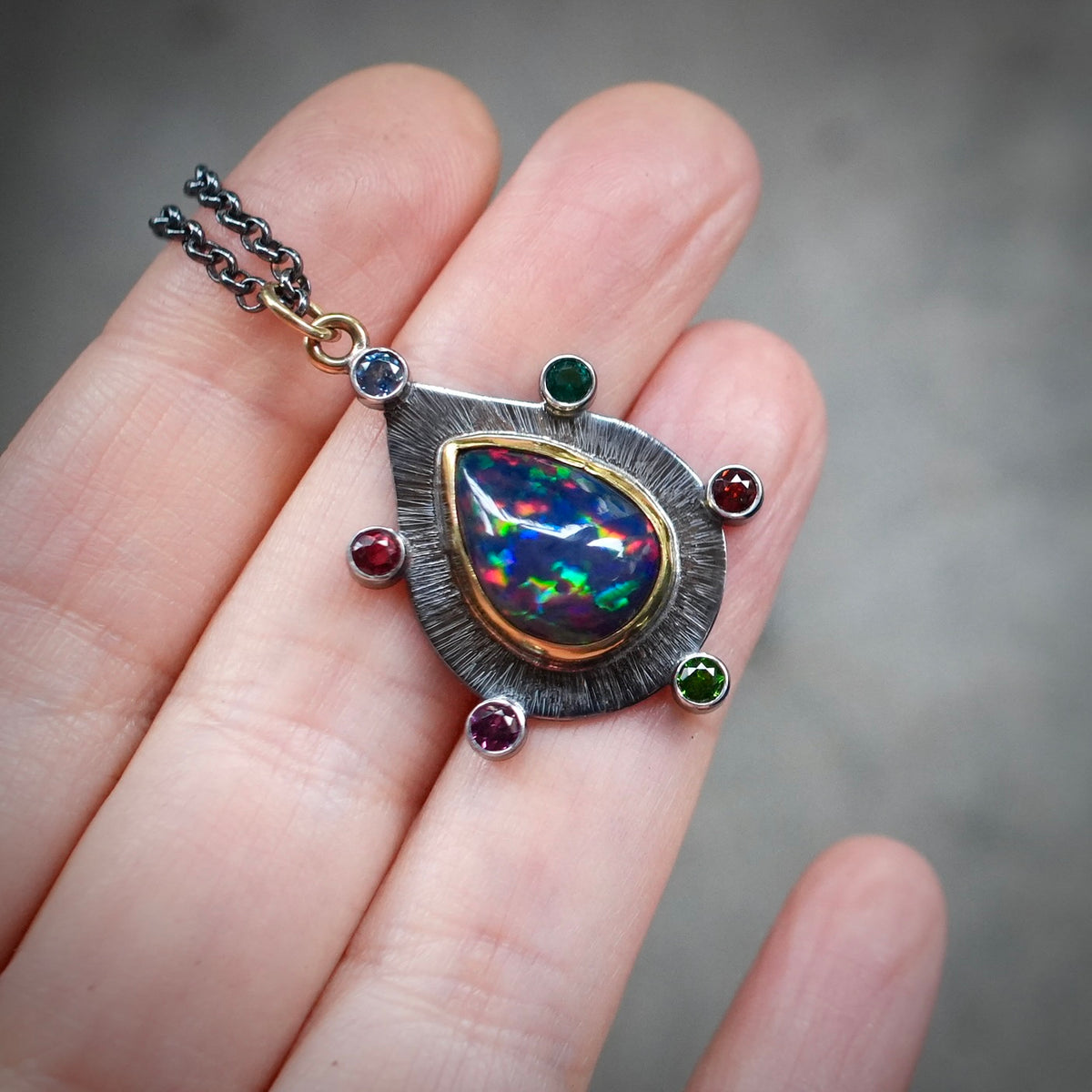 Ethiopian black opal pendant with colorful accents