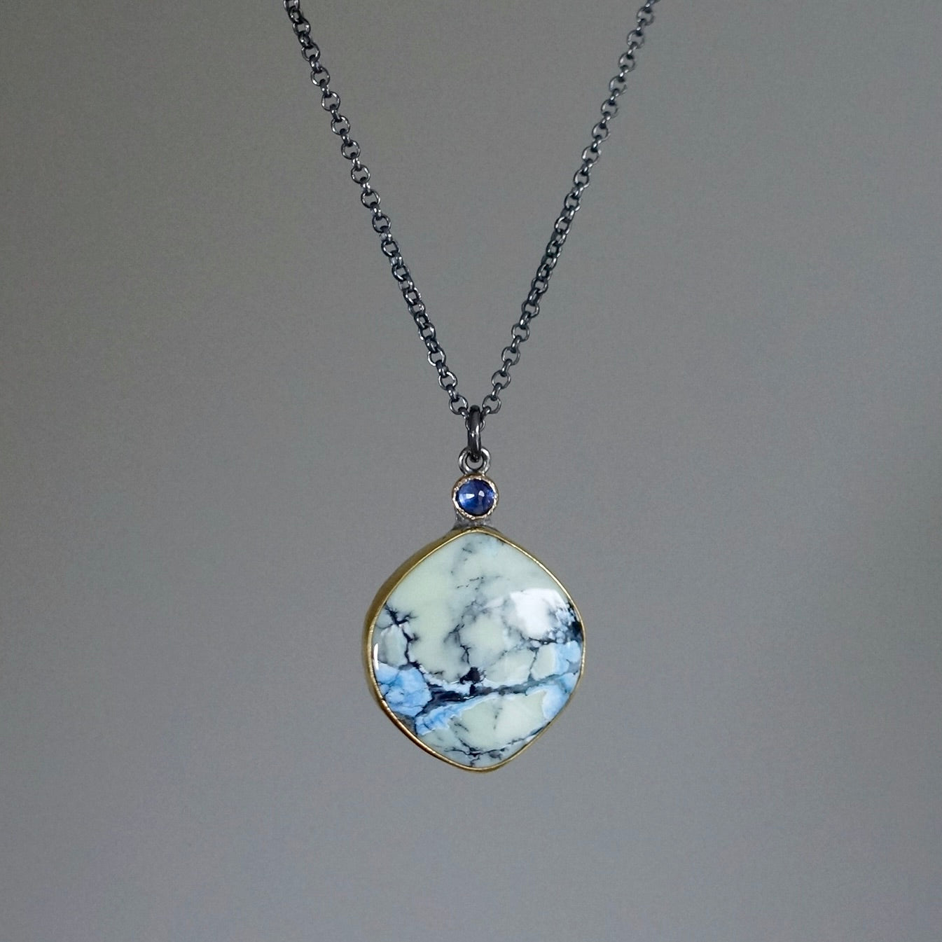 White Hotsonite and blue sapphire pendant