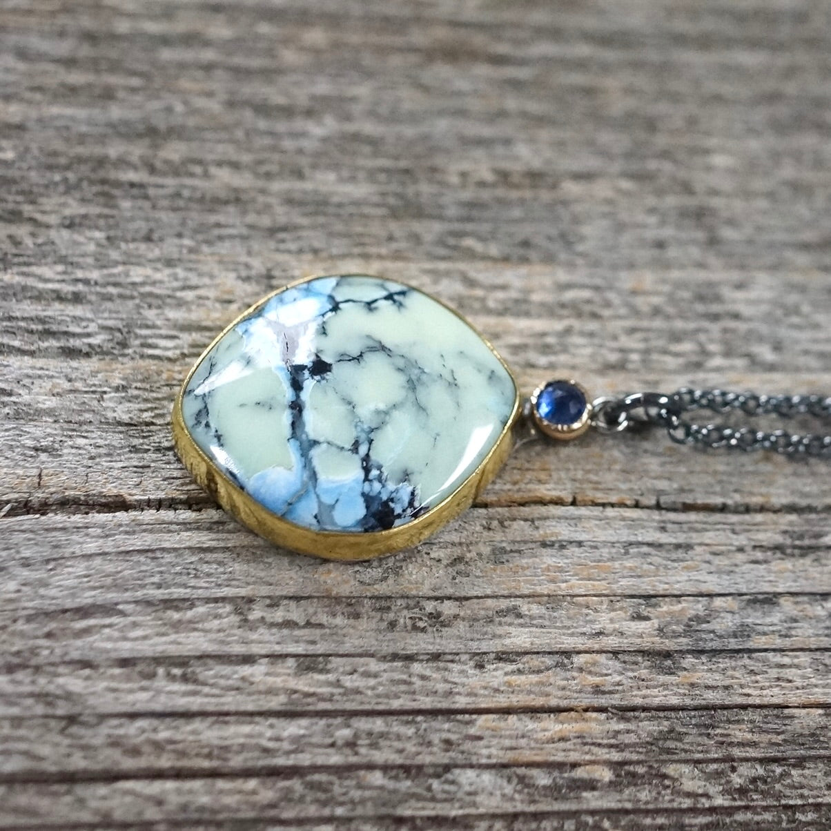 White Hotsonite and blue sapphire pendant