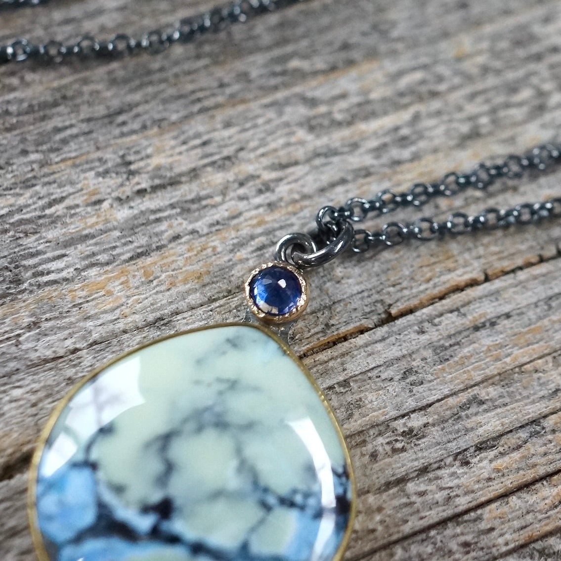 White Hotsonite and blue sapphire pendant