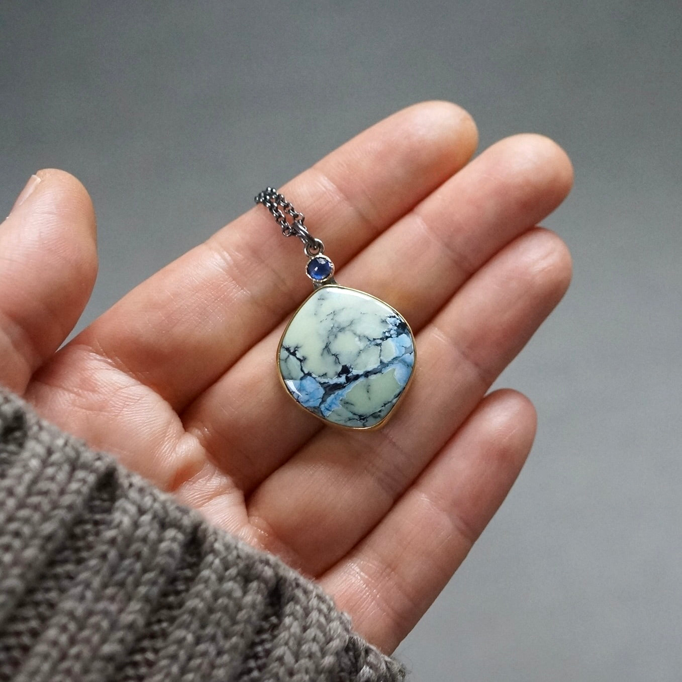 White Hotsonite and blue sapphire pendant