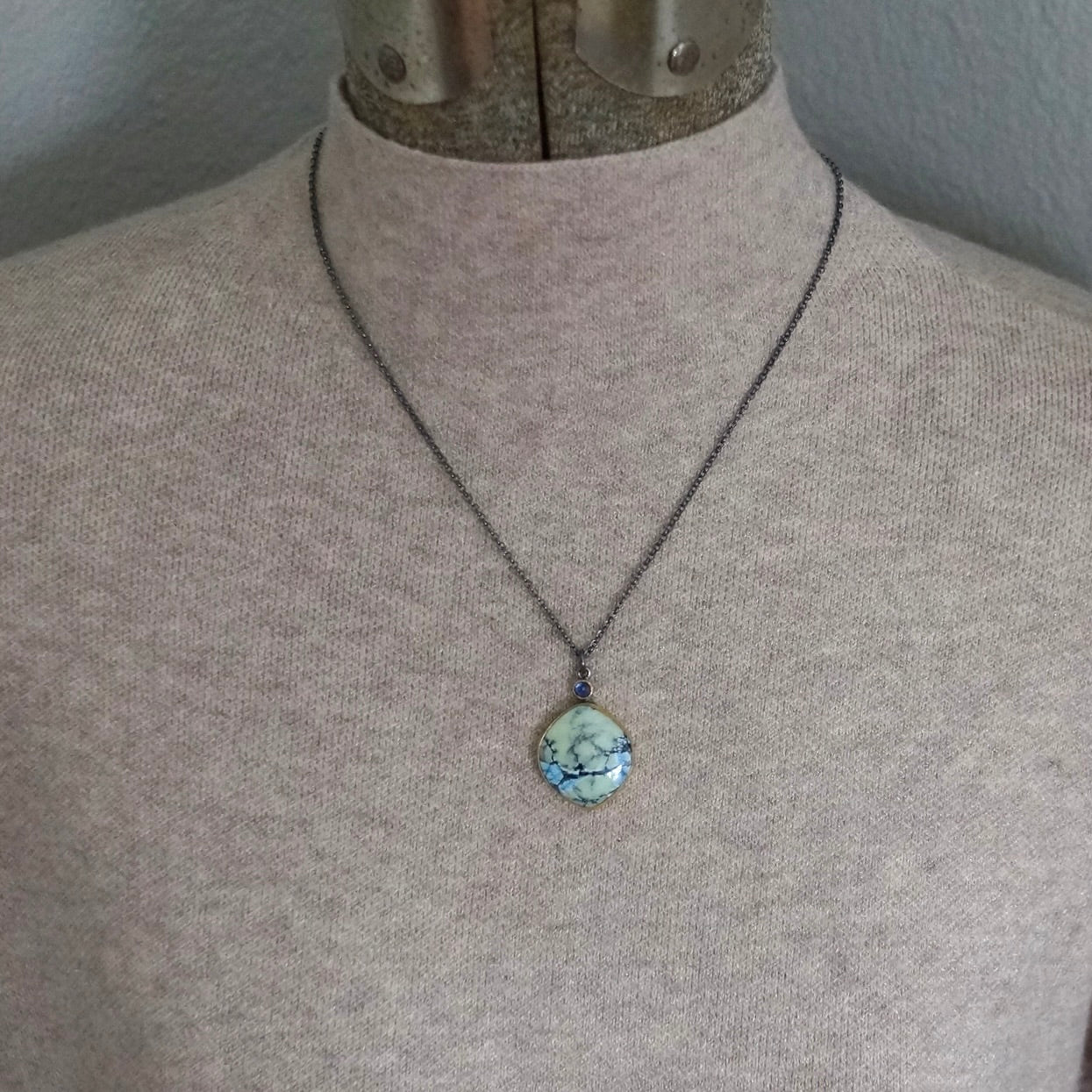 White Hotsonite and blue sapphire pendant