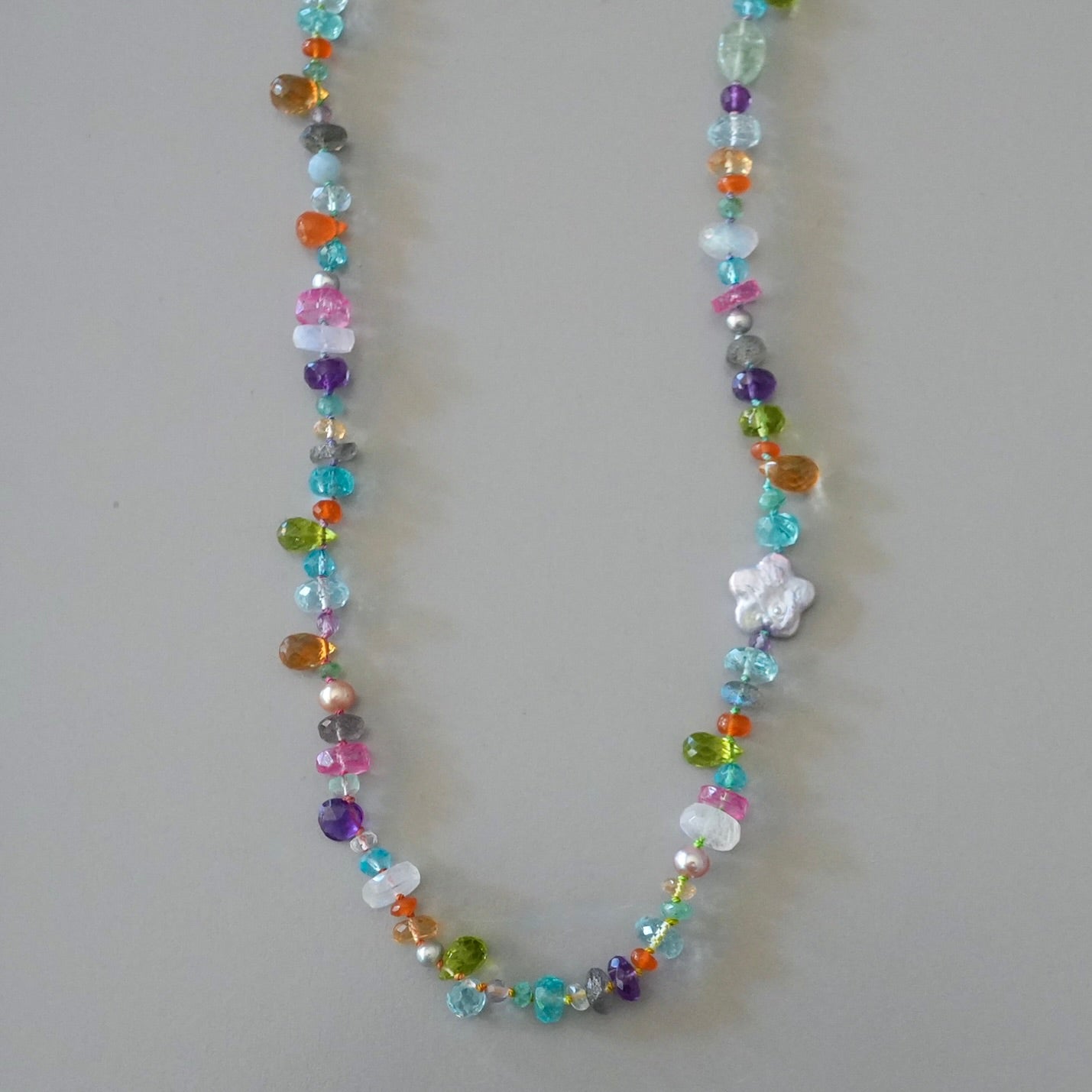 Vibrant gemstone mix silk-knotted necklace with a pearl flower