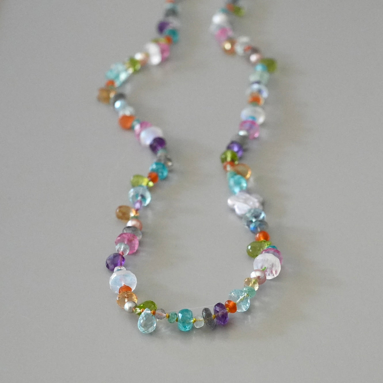 Vibrant gemstone mix silk-knotted necklace with a pearl flower