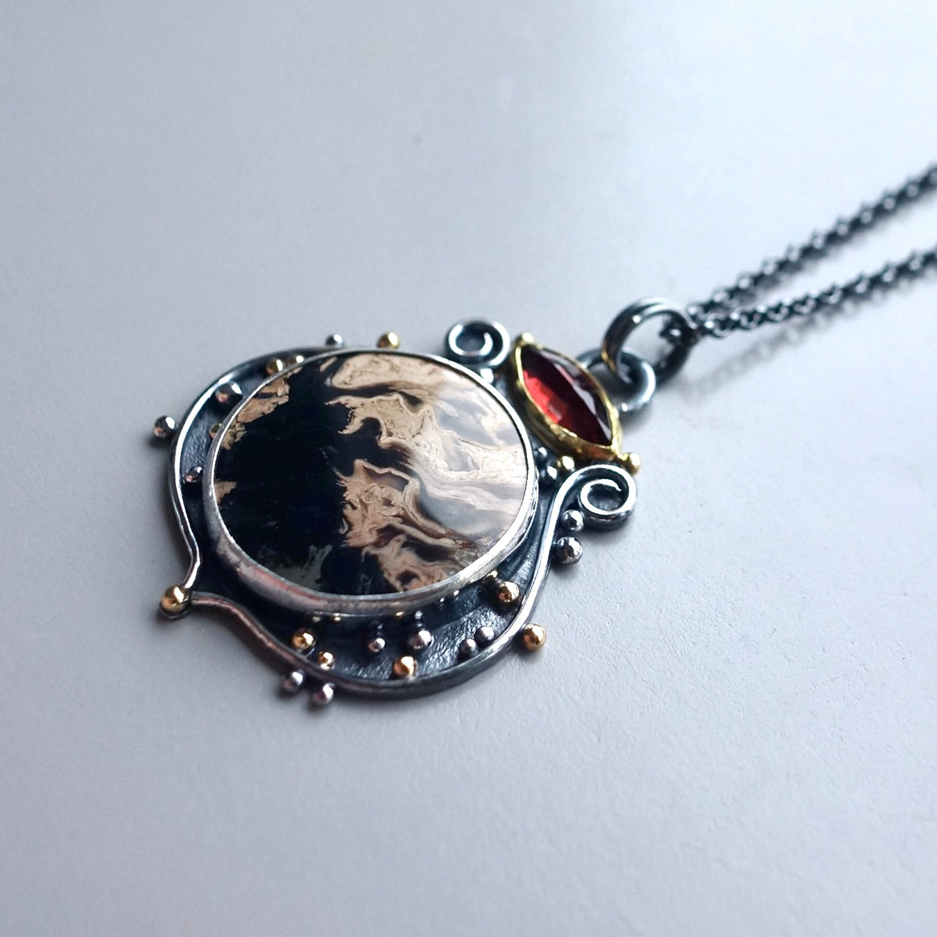 Fossil palm root and garnet pendant