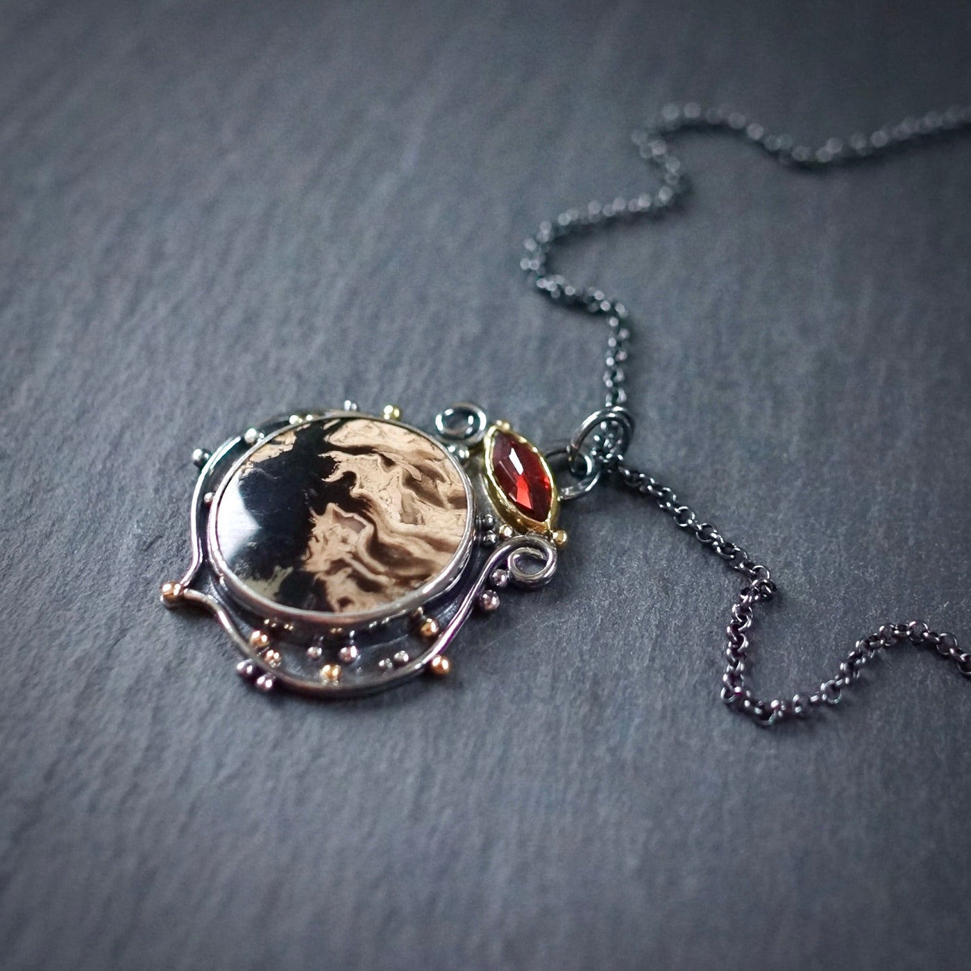 Fossil palm root and garnet pendant