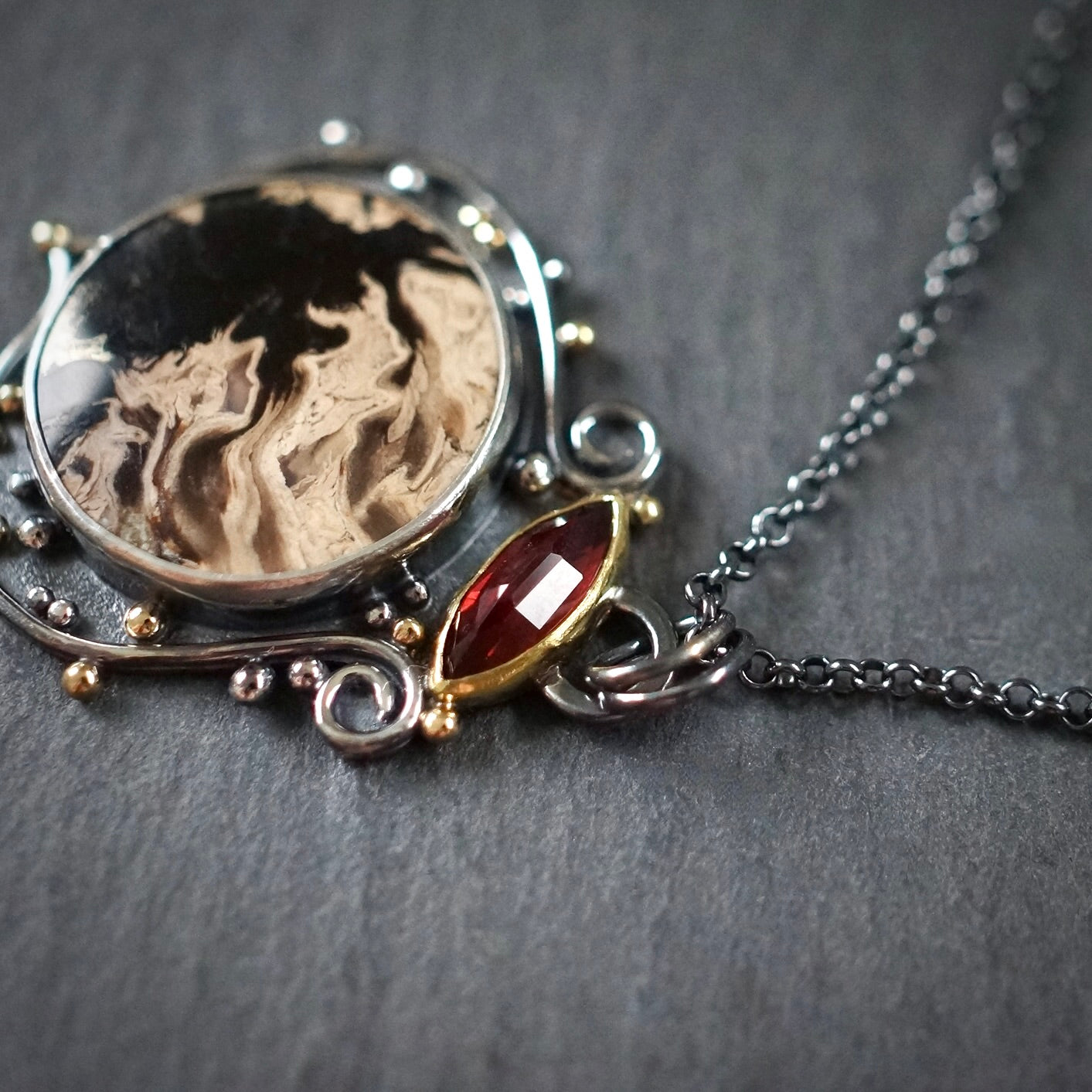 Fossil palm root and garnet pendant
