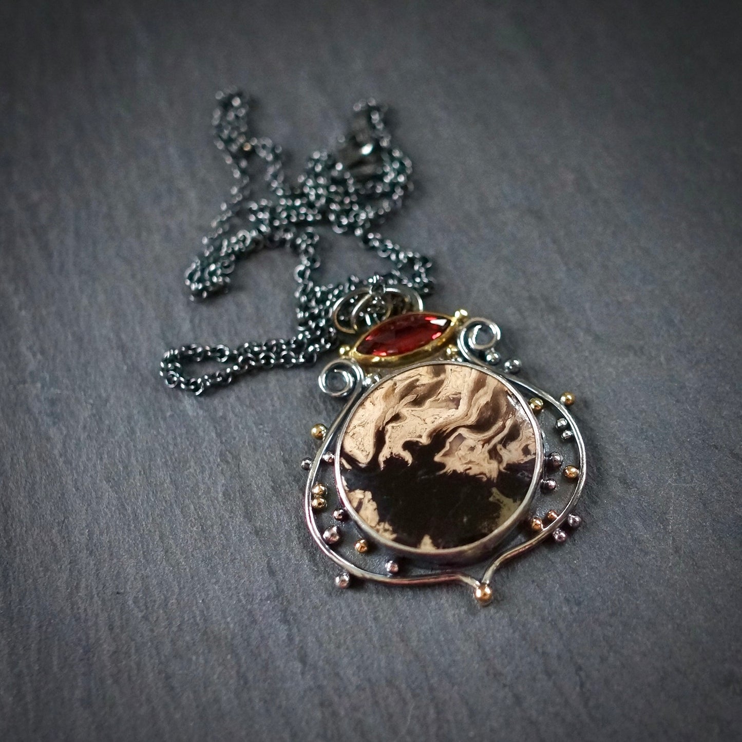 Fossil palm root and garnet pendant
