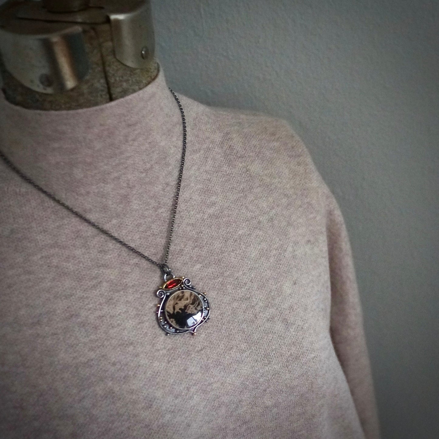 Fossil palm root and garnet pendant