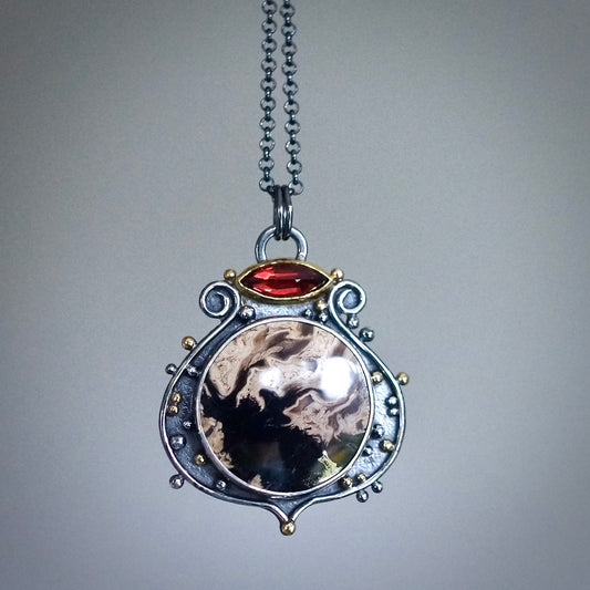 Fossil palm root and garnet pendant